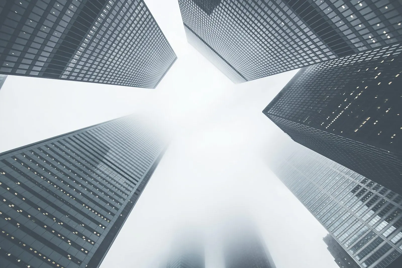 Glass towers rising into the fog